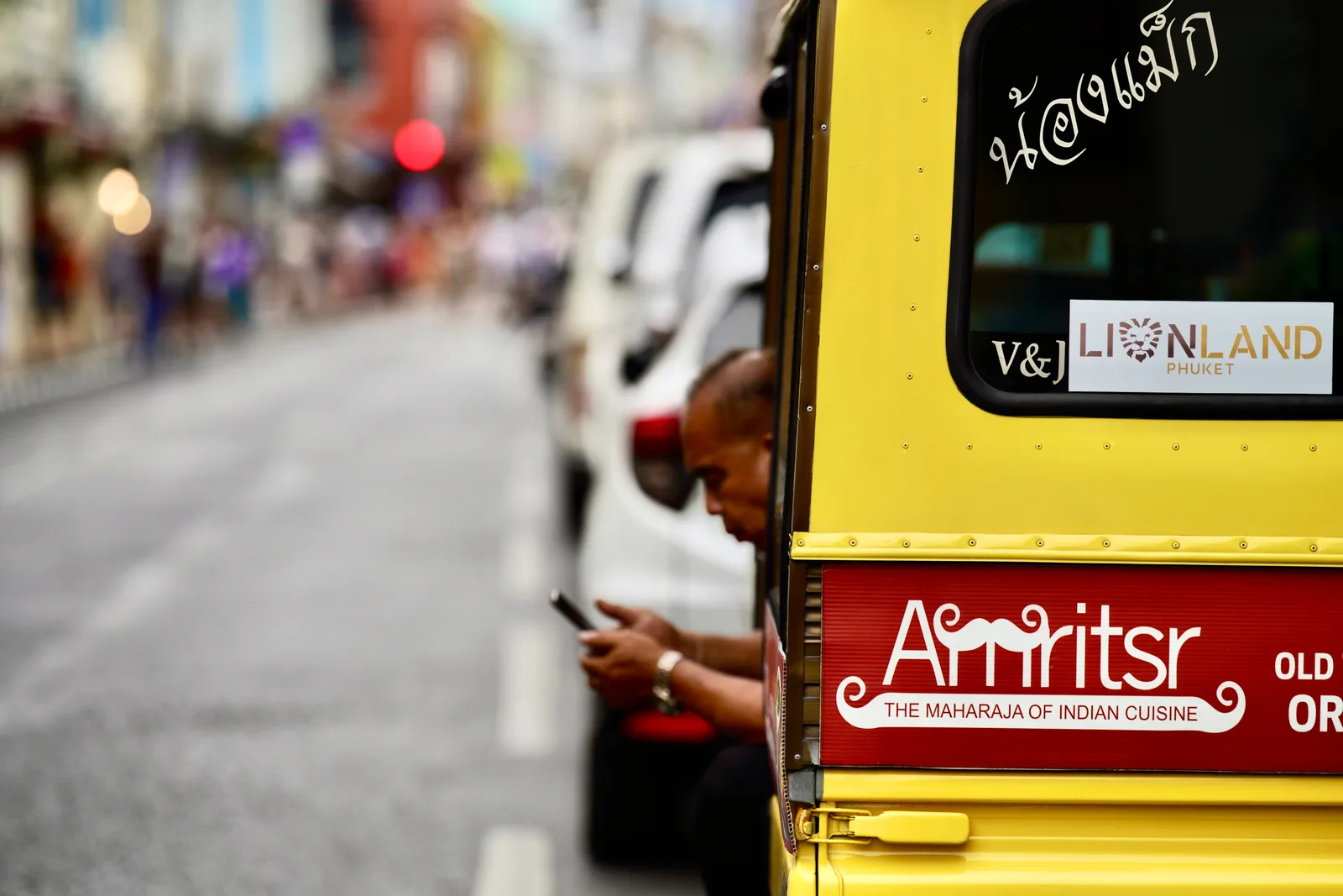 Taxis, the Smart Bus and scooters on a Phuket road, getting around Phuket