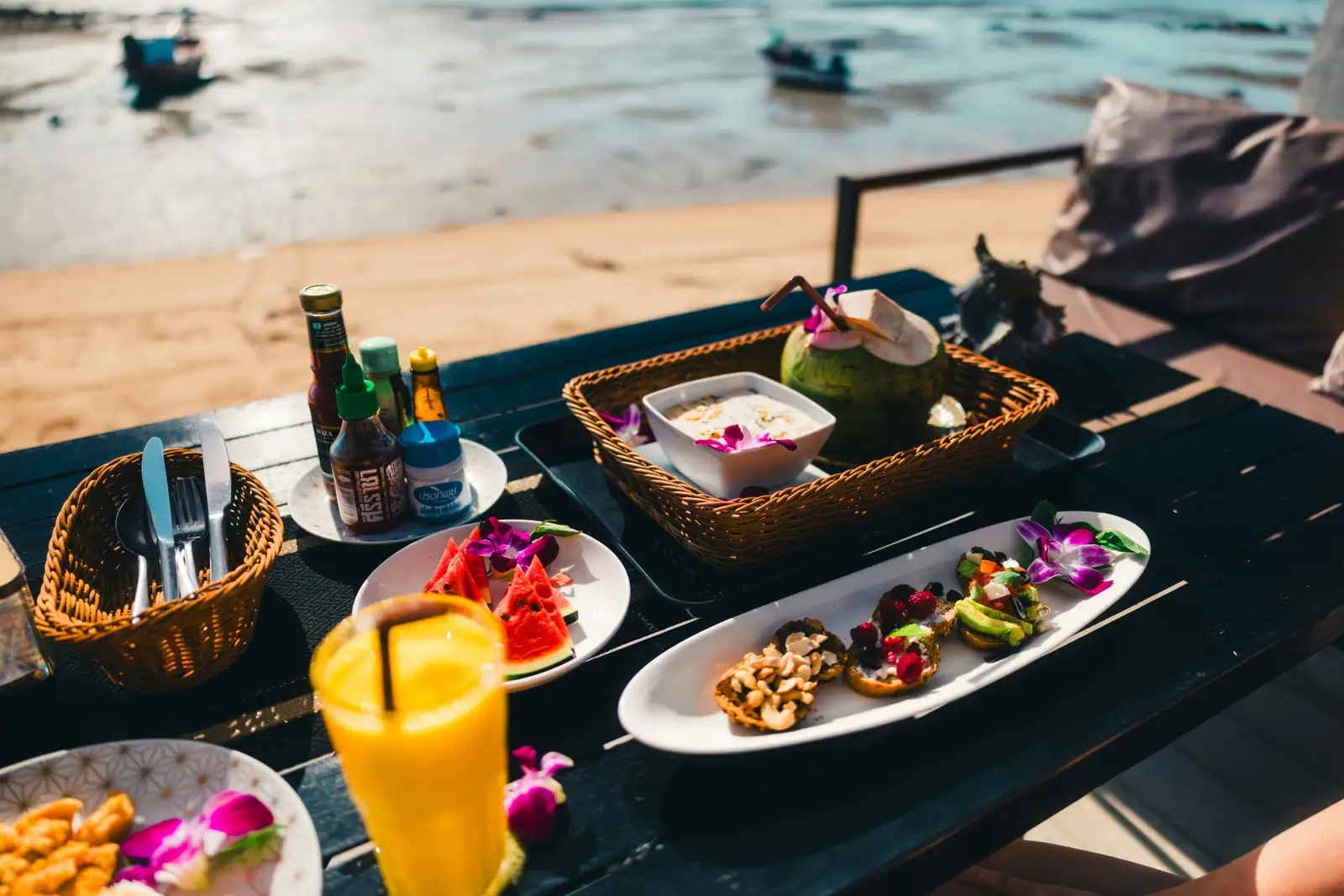 Candlelit terrace table set for two at a romantic restaurant in Phuket at dusk